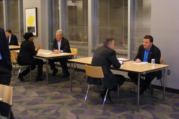 attendees sitting at tables of 2 talking