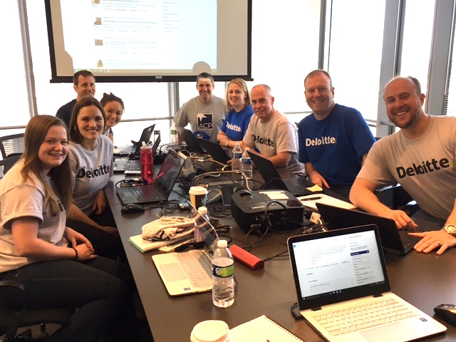 Deloitte employees sitting around conference table